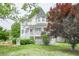 A two-story home with mature trees and greenery creates a peaceful setting at 7245 W Strickland St, Douglasville, GA 30134