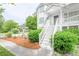 A charming home is framed by a pergola and lush green shrubs at 7245 W Strickland St, Douglasville, GA 30134