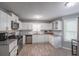 Bright kitchen with white cabinets, granite countertops, and stainless-steel appliances at 7245 W Strickland St, Douglasville, GA 30134
