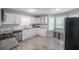 Bright kitchen features modern appliances, white cabinetry and plenty of counter space at 7245 W Strickland St, Douglasville, GA 30134