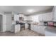 Modern kitchen with stainless steel appliances, sleek white cabinets, and gray countertops at 7245 W Strickland St, Douglasville, GA 30134