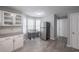 Bright kitchen features stainless steel appliances, a dining area and white cabinets at 7245 W Strickland St, Douglasville, GA 30134