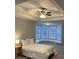 Tranquil bedroom with a tray ceiling, bay windows, and a cozy window seat at 7245 W Strickland St, Douglasville, GA 30134