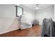 Unfinished basement with white brick walls, wood-look floors, and a window at 1490 Ashbrook Dr, Lawrenceville, GA 30043