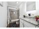 Bathroom showcasing a marble shower, modern vanity, and gray color scheme at 1490 Ashbrook Dr, Lawrenceville, GA 30043