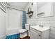 Clean and functional bathroom with white subway tile, a vanity, and a shower-tub combination at 1490 Ashbrook Dr, Lawrenceville, GA 30043