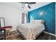 Bedroom features a queen-size bed, window, and designer accent wall at 1490 Ashbrook Dr, Lawrenceville, GA 30043
