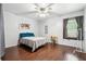 Bedroom with wood floors, queen bed, and plenty of natural light from a window at 1490 Ashbrook Dr, Lawrenceville, GA 30043