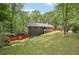 A charming home nestled among lush trees with a well-manicured lawn, offering a serene and private setting at 1490 Ashbrook Dr, Lawrenceville, GA 30043