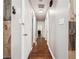 Hallway with hardwood floors and neutral walls, providing access to multiple rooms within the home at 1490 Ashbrook Dr, Lawrenceville, GA 30043