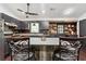 Modern kitchen with an island featuring granite countertops, stainless steel appliances, and pendant lighting at 1490 Ashbrook Dr, Lawrenceville, GA 30043