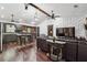 An open-concept living room featuring ceiling fans, dark furniture, and hardwood floors throughout the home at 1490 Ashbrook Dr, Lawrenceville, GA 30043