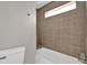 This bathroom features warm-toned tiles, a modern shower, and a white toilet at 1774 Northwick Pl, Lithonia, GA 30058