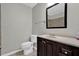 Well-lit bathroom with vanity, framed mirror, and tiled shower at 1774 Northwick Pl, Lithonia, GA 30058