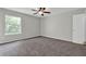 This bedroom is carpeted, has neutral walls, and a ceiling fan, perfect for relaxing or working from home at 1774 Northwick Pl, Lithonia, GA 30058