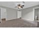 Spacious bedroom with neutral walls, soft carpeting, and a ceiling fan for comfort and style at 1774 Northwick Pl, Lithonia, GA 30058