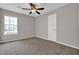 Bright, comfortable bedroom featuring neutral walls, carpet, natural light, and a ceiling fan for comfort at 1774 Northwick Pl, Lithonia, GA 30058