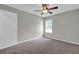 Bedroom with gray walls, carpeted floors, a ceiling fan, and a window at 1774 Northwick Pl, Lithonia, GA 30058