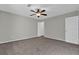 Comfortable bedroom featuring neutral paint, plush carpeting, and a lighted ceiling fan at 1774 Northwick Pl, Lithonia, GA 30058