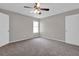 Bedroom features carpeted floors, gray walls, and a ceiling fan at 1774 Northwick Pl, Lithonia, GA 30058