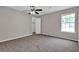 Bright bedroom with carpet, a ceiling fan, a window, and a closet at 1774 Northwick Pl, Lithonia, GA 30058