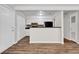 Modern kitchen featuring white cabinets, an eat-in bar, and black appliances at 1774 Northwick Pl, Lithonia, GA 30058