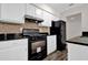 Modern kitchen featuring stainless steel appliances, white cabinetry, and granite countertops at 1774 Northwick Pl, Lithonia, GA 30058