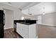 Open kitchen with stainless steel appliances and sleek black countertop with white cabinets at 1774 Northwick Pl, Lithonia, GA 30058