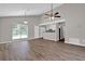 This open-concept living area with hardwood floors is great for entertaining and relaxing at 1774 Northwick Pl, Lithonia, GA 30058