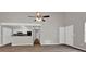 Spacious living room featuring hardwood floors, an open layout, and access to the kitchen area at 1774 Northwick Pl, Lithonia, GA 30058