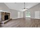 Inviting living room with vaulted ceiling, brick fireplace, ceiling fan, and hardwood flooring at 1774 Northwick Pl, Lithonia, GA 30058