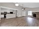 Open-concept living area with vaulted ceilings, hardwood floors, fireplace, and an adjacent kitchen at 1774 Northwick Pl, Lithonia, GA 30058