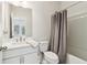 Modern bathroom features a shower with curtain and a toilet at 2865 Ferncliff St, Cumming, GA 30028