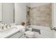 Bright bathroom with tiled shower over tub, and a white vanity at 2865 Ferncliff St, Cumming, GA 30028