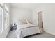 Cozy bedroom featuring neutral tones, natural light, and a door to the bathroom at 2865 Ferncliff St, Cumming, GA 30028