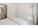 This is an airy bedroom view showcasing neutral walls and flooring with bath access at 2865 Ferncliff St, Cumming, GA 30028