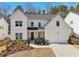 Charming two-story home with white siding, manicured landscaping, and inviting front porch at 2865 Ferncliff St, Cumming, GA 30028