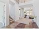 Spacious foyer features soaring ceilings, hardwood floors, staircase, and views into the living room at 2865 Ferncliff St, Cumming, GA 30028