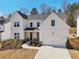 Front exterior featuring a well-manicured lawn, walkway, and a two car garage at 2865 Ferncliff St, Cumming, GA 30028