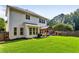 Expansive backyard featuring a well-maintained lawn, patio with pergola, and play area at 301 Downing Creek Trl, Canton, GA 30114