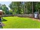 Spacious, well-maintained backyard with lush lawn, wooden fence, and mature trees for privacy at 301 Downing Creek Trl, Canton, GA 30114
