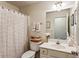 Cozy bathroom featuring a shower-tub combo, white vanity, and decorative accents at 301 Downing Creek Trl, Canton, GA 30114