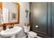 Stylish powder room featuring wood-framed mirror, pedestal sink, and elegant wall decor creating a cozy and inviting space at 301 Downing Creek Trl, Canton, GA 30114