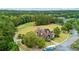 Aerial shot showcases the clubhouse overlooking the golf course, complemented by the lush landscape at 301 Downing Creek Trl, Canton, GA 30114