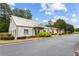The community clubhouse has light gray siding, multiple front entrances, and attractive bushes and flowers at 301 Downing Creek Trl, Canton, GA 30114
