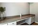 A clean, functional desk area features a long countertop, base cabinets, and a neutral color palette, ideal for a home office at 301 Downing Creek Trl, Canton, GA 30114