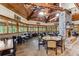 Spacious dining area with wooden tables, chairs, fireplace, and vaulted wood-beam ceilings at 301 Downing Creek Trl, Canton, GA 30114