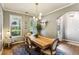Bright dining room featuring a modern chandelier, large windows, and stylish decor, perfect for gatherings at 301 Downing Creek Trl, Canton, GA 30114