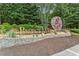 Attractive stone entrance sign for BridgeMill neighborhood with landscaping and a water wheel feature at 301 Downing Creek Trl, Canton, GA 30114