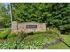 Charming stone entrance sign for BridgeMill neighborhood with colorful landscaping and greenery at 301 Downing Creek Trl, Canton, GA 30114